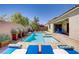 Stunning backyard pool and spa with lush landscaping and comfortable lounge seating, perfect for relaxation and entertaining at 9779 Mosaic Canyon Ct, Las Vegas, NV 89149