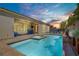 Tranquil pool with spa and patio area, complemented by lush landscaping and a covered patio at 9779 Mosaic Canyon Ct, Las Vegas, NV 89149