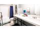 Well-lit bathroom with double sinks, dark cabinetry, and a combined shower/tub with stylish fixtures at 10262 Havasu Falls St, Las Vegas, NV 89141
