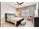Comfortable bedroom with ceiling fan features neutral walls, carpet, and natural lighting at 10262 Havasu Falls St, Las Vegas, NV 89141