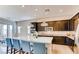 Bright kitchen featuring a large island with seating, modern appliances, and dark cabinets with bright countertops at 10262 Havasu Falls St, Las Vegas, NV 89141