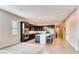 Modern kitchen with dark cabinets, stainless steel appliances, an island and bar stool seating at 10262 Havasu Falls St, Las Vegas, NV 89141