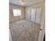 This bedroom features neutral walls, window, neutral carpeting, ceiling fan, and a closet with sliding doors at 10455 Alpine Edge Ave, Las Vegas, NV 89129