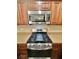 Stainless steel gas range and microwave are mounted in wood cabinets at 10455 Alpine Edge Ave, Las Vegas, NV 89129