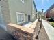 Exterior patio with a decorative stone wall and desert landscaping at 10455 Alpine Edge Ave, Las Vegas, NV 89129