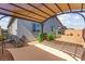A charming covered backyard pergola next to the house with a decorative sunshade at 10951 Stone Crossing Ave, Las Vegas, NV 89166