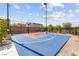 Community basketball court with fencing and mature trees at 10951 Stone Crossing Ave, Las Vegas, NV 89166