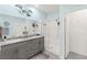 Modern bathroom with double sinks, granite countertops, and a sleek glass shower at 10951 Stone Crossing Ave, Las Vegas, NV 89166