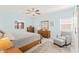 Bright bedroom with a ceiling fan, a comfy chair and ottoman, and ample natural light at 10951 Stone Crossing Ave, Las Vegas, NV 89166