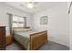 Cozy bedroom featuring a wooden bed frame, soft carpet, and a ceiling fan for a comfortable atmosphere at 10951 Stone Crossing Ave, Las Vegas, NV 89166