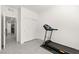Well-lit spare room with a new treadmill, and easy access to closet and other rooms at 10951 Stone Crossing Ave, Las Vegas, NV 89166