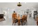 Spacious dining area with wooden table and chairs, adjacent to the open kitchen and living spaces at 10951 Stone Crossing Ave, Las Vegas, NV 89166