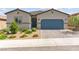 Charming single-story home with a well-maintained yard and a blue garage door at 10951 Stone Crossing Ave, Las Vegas, NV 89166