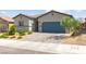 Attractive single-story home with desert landscaping and a blue garage door at 10951 Stone Crossing Ave, Las Vegas, NV 89166