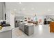 Spacious kitchen featuring gray cabinets, a large island, and stainless steel appliances at 10951 Stone Crossing Ave, Las Vegas, NV 89166