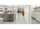 Open concept kitchen with gray cabinets and an island, adjacent to the dining and laundry areas at 10951 Stone Crossing Ave, Las Vegas, NV 89166
