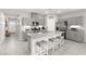 Modern kitchen with stainless steel appliances, gray cabinets, and a spacious island with seating at 10951 Stone Crossing Ave, Las Vegas, NV 89166
