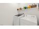 Practical laundry room with modern appliances and convenient storage shelves at 10951 Stone Crossing Ave, Las Vegas, NV 89166
