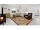 Cozy living room with a comfortable sectional sofa, decorative rug, and neutral tones at 10951 Stone Crossing Ave, Las Vegas, NV 89166