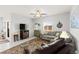 Comfortable living room featuring neutral tones, plush seating, and a decorative ceiling fan at 10951 Stone Crossing Ave, Las Vegas, NV 89166