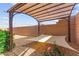 Shaded pergola area in backyard featuring a sunshade sail at 10951 Stone Crossing Ave, Las Vegas, NV 89166