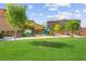 Community playground and picnic area with lush green grass and mature trees at 10951 Stone Crossing Ave, Las Vegas, NV 89166