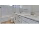 Bright bathroom with white cabinetry, double sinks, and a shower-tub combination at 11552 Ashy Storm Ave, Las Vegas, NV 89138