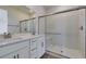 Contemporary bathroom with double vanity and glass-enclosed walk-in shower at 11552 Ashy Storm Ave, Las Vegas, NV 89138