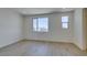 Spacious bedroom with light wood floors and large windows with views at 11552 Ashy Storm Ave, Las Vegas, NV 89138