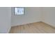 Empty bedroom with white walls, trim and light vinyl floors with natural sunlight at 11552 Ashy Storm Ave, Las Vegas, NV 89138