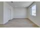 Bright bedroom featuring light wood floors, a large window, and neutral decor at 11552 Ashy Storm Ave, Las Vegas, NV 89138