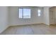Spacious bedroom with light wood floors and large windows overlooking mountains at 11552 Ashy Storm Ave, Las Vegas, NV 89138