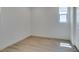 A bright, empty bedroom featuring sleek flooring and a window at 11552 Ashy Storm Ave, Las Vegas, NV 89138