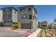 Modern home exterior with a two-car garage and drought-resistant landscaping in a planned community at 11552 Ashy Storm Ave, Las Vegas, NV 89138