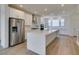 Contemporary kitchen with quartz island, stainless appliances, and subway tile backsplash at 11552 Ashy Storm Ave, Las Vegas, NV 89138