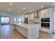 Modern kitchen with stainless appliances, a central island, and plenty of natural light at 11552 Ashy Storm Ave, Las Vegas, NV 89138