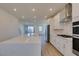 Open-concept kitchen featuring a large island, stainless steel appliances and access to balcony at 11552 Ashy Storm Ave, Las Vegas, NV 89138