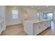 Bright kitchen featuring modern appliances, a central island, and stairs at 11552 Ashy Storm Ave, Las Vegas, NV 89138