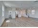 Spacious open-concept living room flows into the kitchen, featuring wood-look floors, a staircase, and modern finishes at 11552 Ashy Storm Ave, Las Vegas, NV 89138