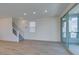 Inviting living room featuring hardwood floors, staircase, and sliding glass doors at 11552 Ashy Storm Ave, Las Vegas, NV 89138