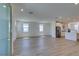 Bright open-concept living room features modern finishes, wood-look flooring, and access to the kitchen at 11552 Ashy Storm Ave, Las Vegas, NV 89138