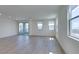 Bright living room featuring wood-look floors and a sliding door that opens to a balcony at 11552 Ashy Storm Ave, Las Vegas, NV 89138