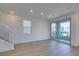 Open living area featuring hardwood floors, large sliding glass doors, and multiple windows at 11552 Ashy Storm Ave, Las Vegas, NV 89138
