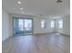 Bright, open living room with hardwood floors, large sliding glass doors, and multiple windows at 11552 Ashy Storm Ave, Las Vegas, NV 89138
