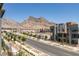 A neighborhood street showcasing contemporary homes with a backdrop of scenic mountains at 11552 Ashy Storm Ave, Las Vegas, NV 89138