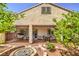 Covered patio overlooks a backyard with a custom fire pit, outdoor seating, and mature landscaping at 11625 Cabo Del Verde Ave, Las Vegas, NV 89138