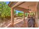 Inviting covered back patio with ceiling fans, outdoor dining area, and barbecue, perfect for entertaining at 11625 Cabo Del Verde Ave, Las Vegas, NV 89138