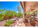 Charming backyard with a custom fire pit, lush landscaping, and a cozy swing for relaxation at 11625 Cabo Del Verde Ave, Las Vegas, NV 89138
