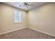 Bedroom featuring neutral walls, carpet, ceiling fan, and plantation shutters at 11625 Cabo Del Verde Ave, Las Vegas, NV 89138