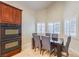 Cozy dining area with modern table and chairs and lots of natural light from the window at 11625 Cabo Del Verde Ave, Las Vegas, NV 89138